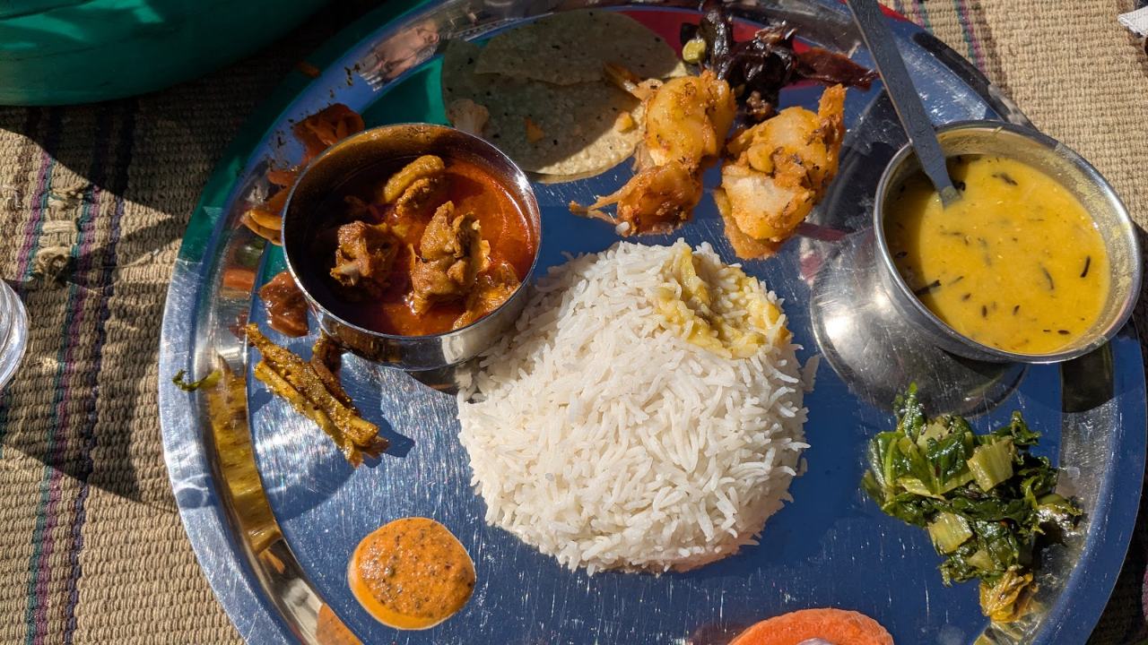 Thakali dal bhat thali with curry, pickle and greens