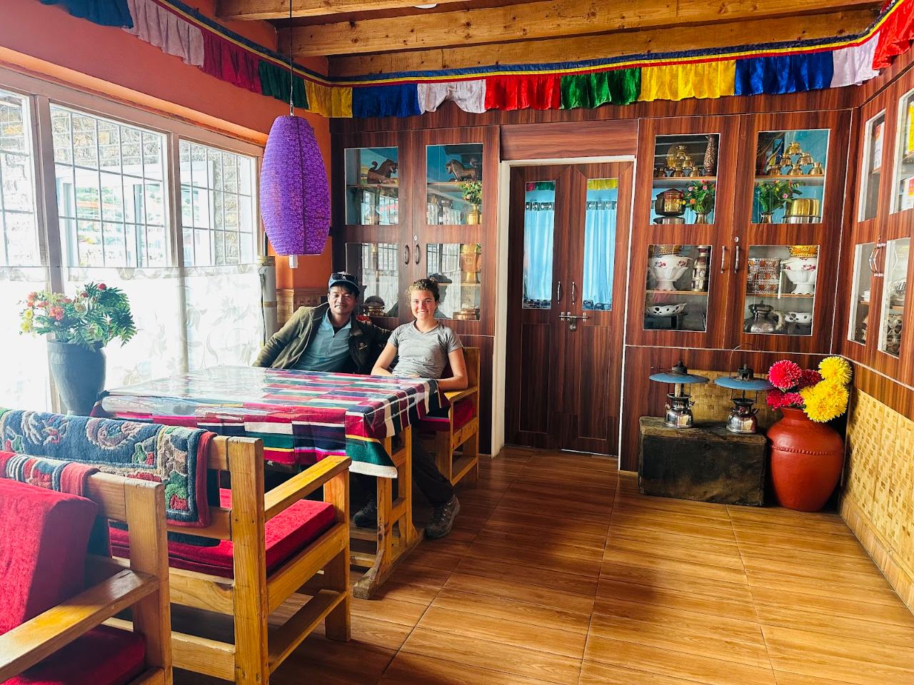 Guests relaxing in the sunlit dining hall